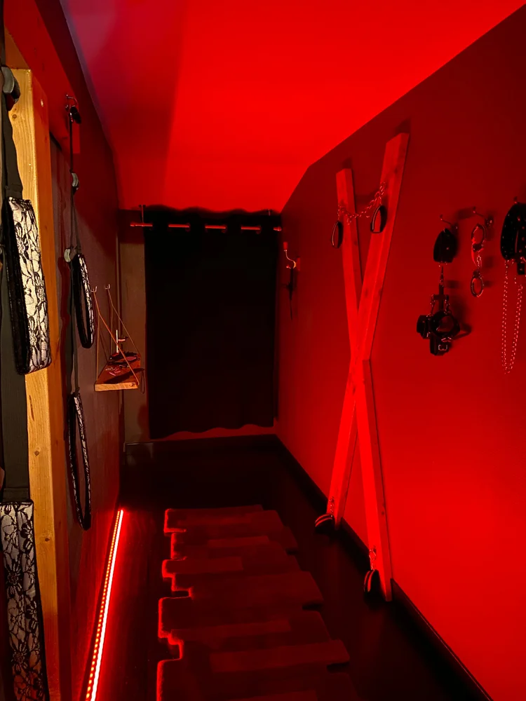 Couloir baigné de lumière rouge vers la love room